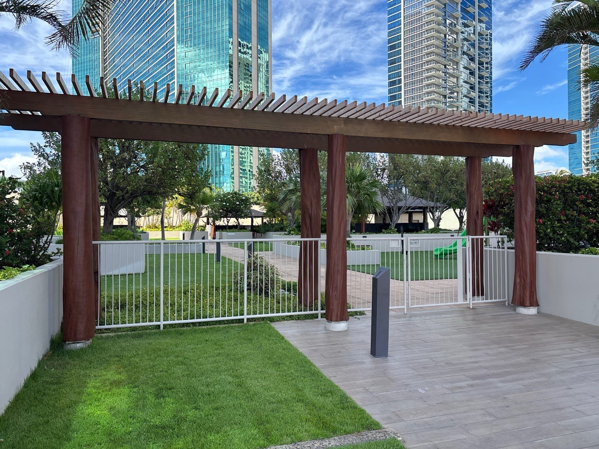 High-rise amenity deck in Kakaʻako with a stained timber pergola