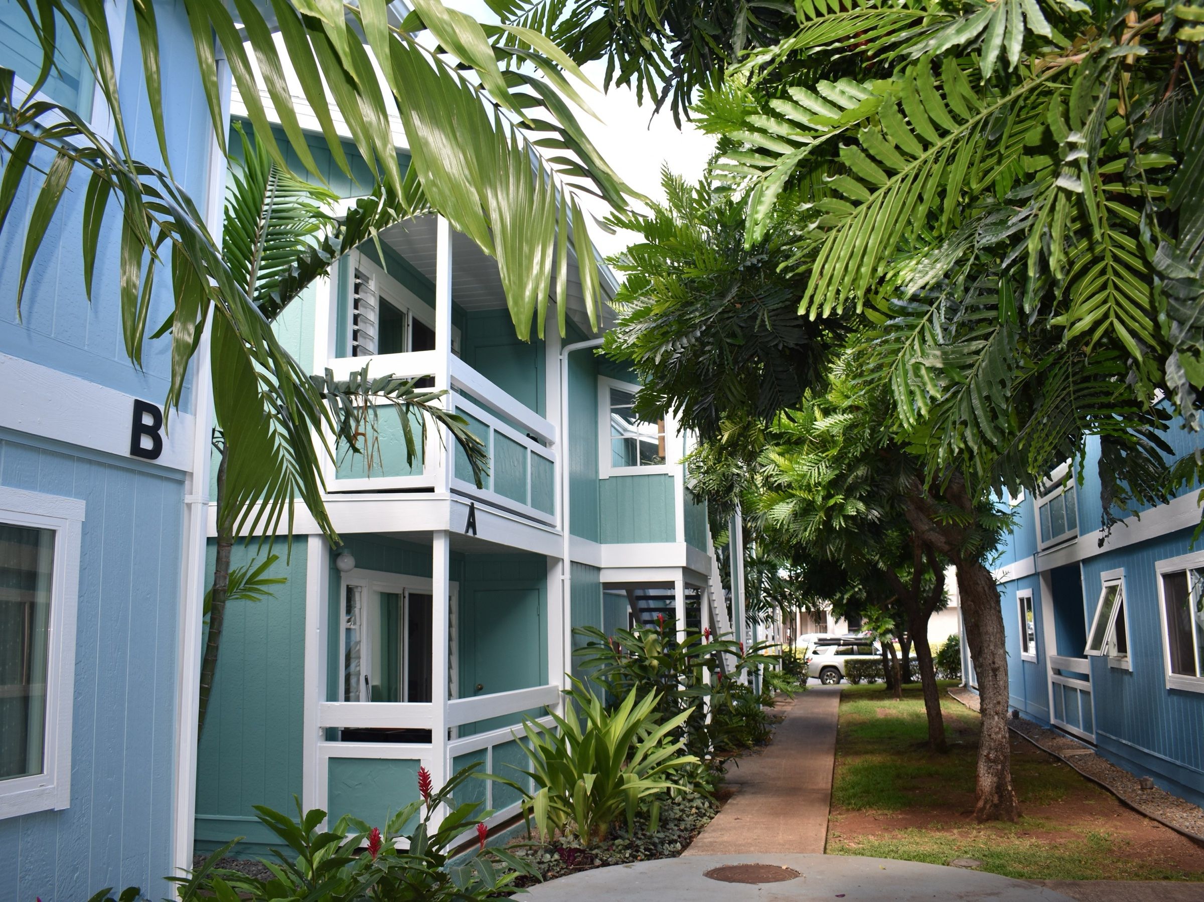 Kailua townhome complex painted sky blue and aqua with white trim