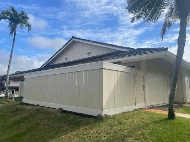 The same townhome fence wall repaired and painted cream with white trim