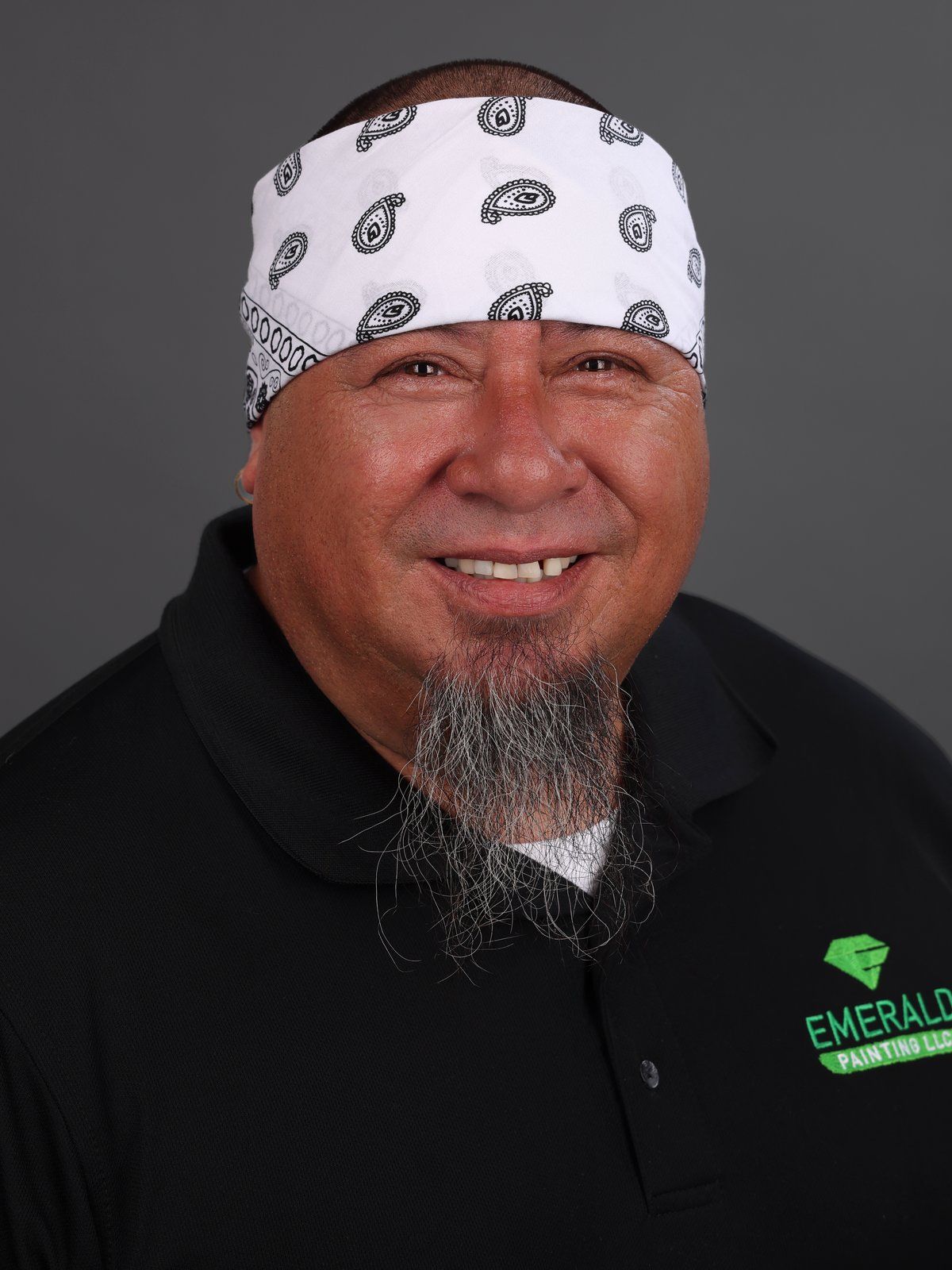 Guy Kane in a white bandana and black Emerald Painting polo