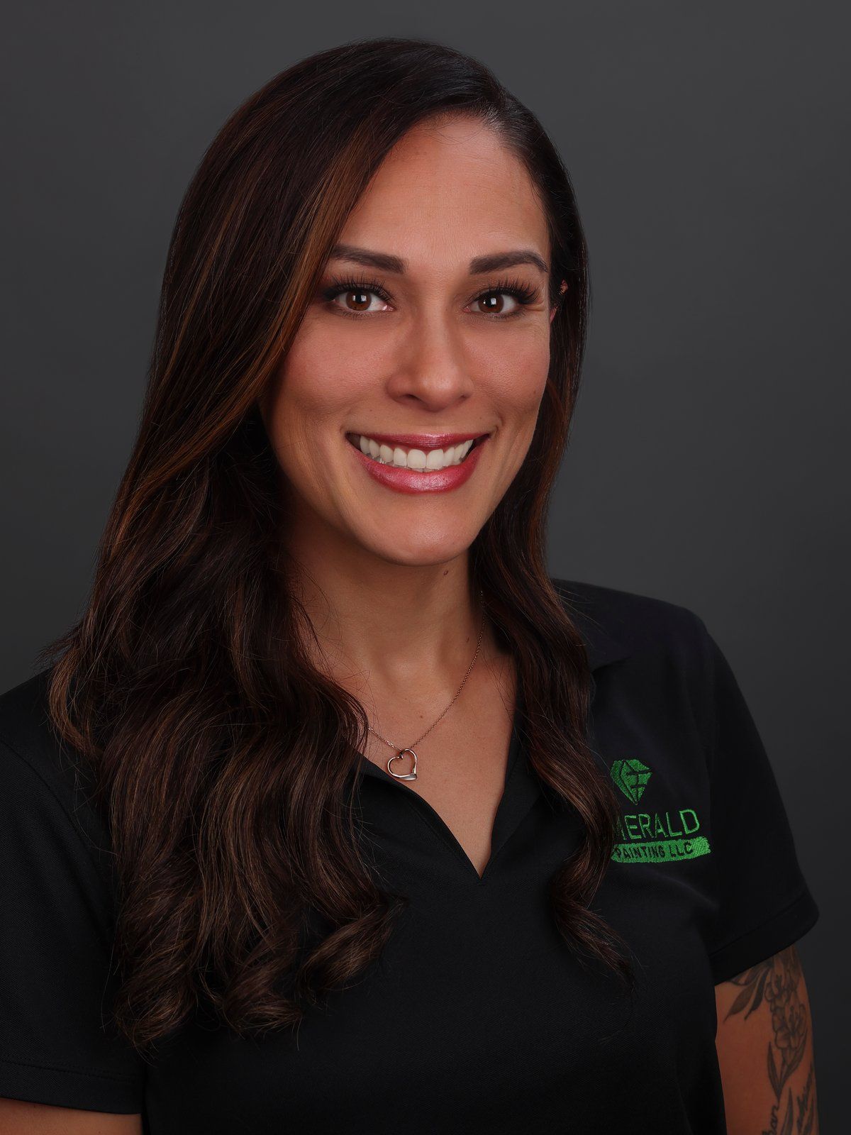 Justine Medeiros in a black Emerald Painting polo