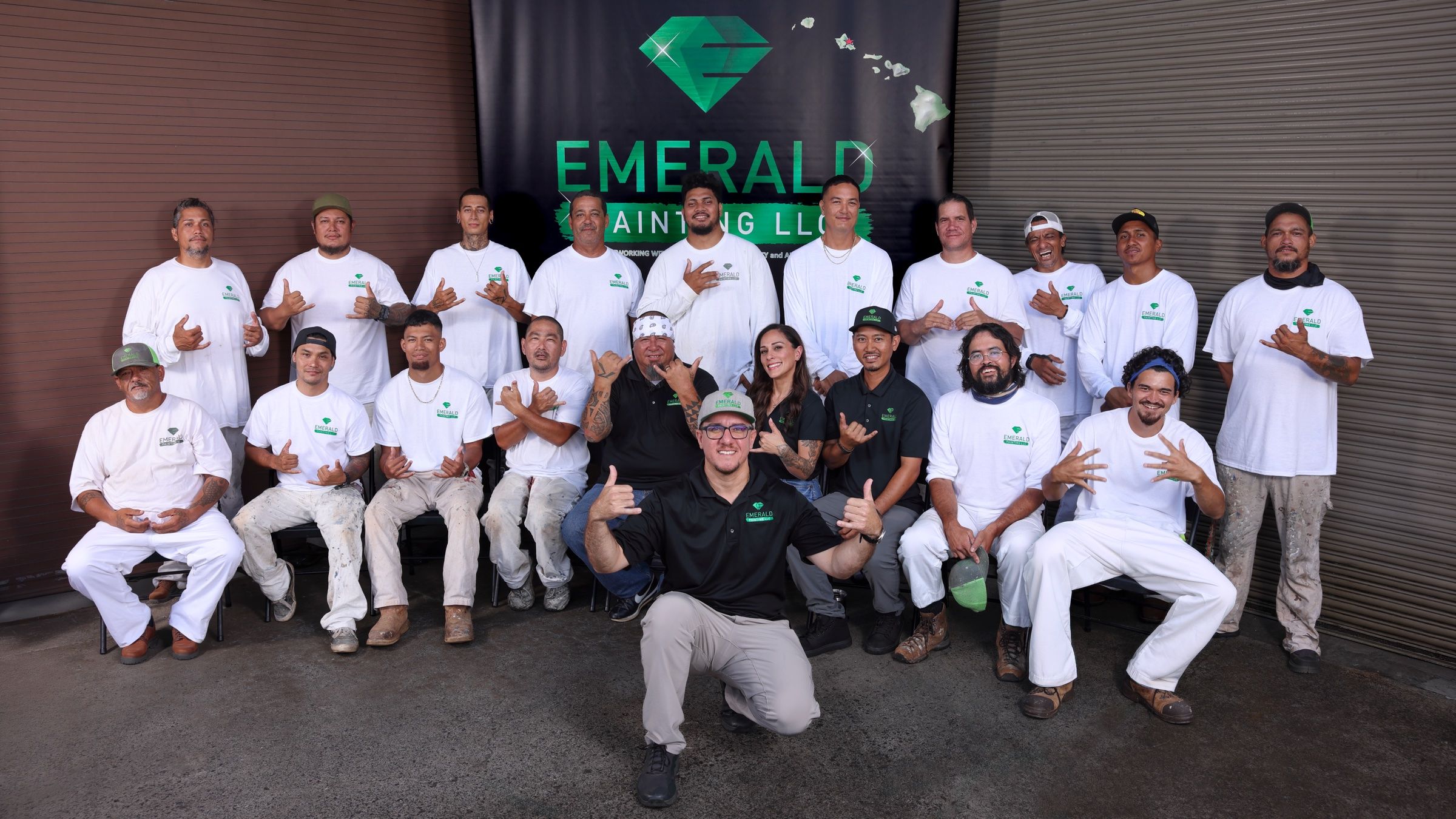 The Emerald Painting company outside, throwing shakas